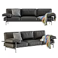 Black Leather Three Seater Sofa With Throw Pillow And Colorful Blanket On Metal Legs