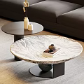 Round Marble Coffee Table With Black Base And Small Side Table Near Sofa With Decor