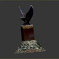Eagle Sculpture Perched On Red Pillar With Colorful Stones At Base