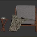 Gray Cushioned Chair With Wooden Armrests Plaid Blanket And Cross Legged Side Table With Books