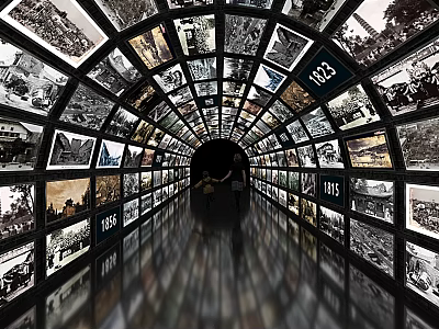 Tunnel of Screens Displaying Black and White Photos with Years and Person Walking 3d model
