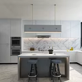 Chandelier Above Modern Kitchen Island With White Cabinets And Marble Backsplash