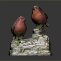 Red Bird Figurines Perched On White Base With Green Moss