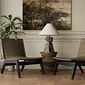 Woven Lounge Chairs with Table Lamp on Wooden Base and Wall Art in Cozy Room with Potted Plant and Wooden Flooring