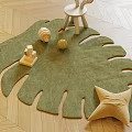 Leaf Shaped Green Rug on Wooden Floor with Wooden Toys White Chair and Star Pillow