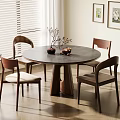 Modern Round Wooden Dining Table Set with Four Upholstered Chairs and Decorative Vases