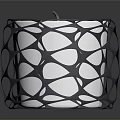Black Intricate Cutout Candle Holder With White Candle And Modern Design
