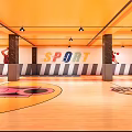 Basketball Court Interior With Orange Ceiling Red Orange Floor Basketball Hoops And Athlete Poster On Wall