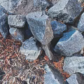 Large Rough Stone Blocks And Small Wood Chips In Outdoor Garden Area