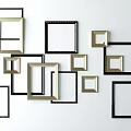 Stylish Assorted Photo Frames In Black And Gold On White Wall