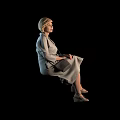 Elegant Woman with Short Hair in Grey Dress Sitting with Crossed Legs Against Black Background