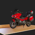 Red Modern Touring Motorcycle With Black Accents And Rear Storage Case