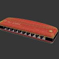 Red Hohner Harmonica With Smooth Metallic Surface And Multiple Reflective Holes
