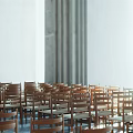 Wooden Chairs In Religious Gathering Place With White Walls Curtains And Natural Light