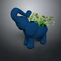 Green Leafy Plant in Blue Elephant Shaped Planter with Fresh Green Foliage