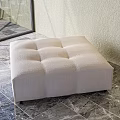 Beige Tufted Ottoman with Soft Upholstered Fabric on Marble Floor in Modern Indoor Setting