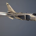 Military Fighter Jet Flying At High Speed With Visible Jet Trail In Clear Blue Sky
