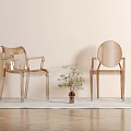 Two Transparent Acrylic Dining Chairs On Light Wooden Floor With Rug And Small Potted Plant