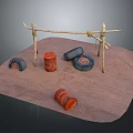Outdoor Desert Camp Structure With Branch Frame Red Drums And Black Tires On Sandy Ground