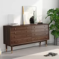 Modern Wooden Chest of Drawers with Golden Handles and Decorative Painting Near Green Plant