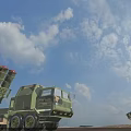 Military Missile Launch Vehicles In Open Field During Sunset With Cloudy Sky