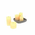 Cream Colored Cylindrical Lit Candles With Gray Stone Tray And Flames