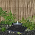 Tranquil Garden Landscape Featuring Circular Water Fountain Lush Green Plants Bamboo Fence And Pebbles