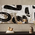Abstract Painting With Black Irregular Shapes And White Textured Background On Wall With Decorative Vase