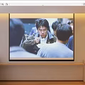 Projection Monitoring Live Feed Displayed on Large Screen Showing Group Interaction