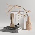 Modern Vase With Speckled Texture Holding Slender Beige Blossom Branches On Books