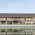 Modern Wooden Building With Black Roof Large Windows And Waterfront Reflection