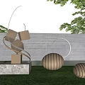 Landscape Sculpture With Bronze Cubes Spheres Curved Metal Structure On Grass Lawn Against Brick Wall