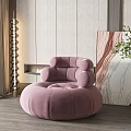 Pink Round Velvet Single Sofa in Modern Living Room with Stylish Decor and Green Plants