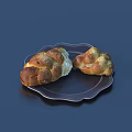 Two Fresh Braided Bread Loaves on Black Plate with Bitten Piece