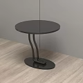 Modern Black Round Side Table With Curved Metal Legs On Wooden Floor
