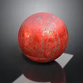 Red Textured Ball With White Stitching Lines On Dark Reflective Surface