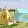 Outdoor Campsite With Yellow Teepee Tent And Light Blue Cabin Style Tent On Green Lawn