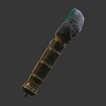 Ornate Golden Decorative Scepter With Green Gemstone Top And Textured Surface