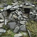 Ancient Stone Hut Structure With Stacked Stones Moss And Stone Doorway