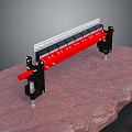 Red And Black Mechanical Clamp Tool With Metal Structure Mounted On Rock Slab 3d model
