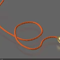 Coiled Orange Decorative Rope With Gold Ball At End On Blue Surface