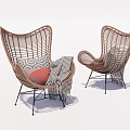 Stylish Rattan Leisure Chair With Black Metal Legs And Decorative Pillows Blanket