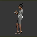 Woman In Gray Dress With White Apron Holding Object Standing On Gray Background