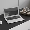 Silver Laptop with White Mouse and Headphones on Black Desk with Books