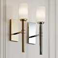 Modern Brass and Chrome Wall Sconces with Cylindrical Lampshades on White Wall
