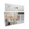 Modern Clothing Store Interior With Clothing Racks Hanging Clothes Sofa Plant And Lighting
