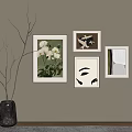 Elegant Wall Art Display With Framed Paintings And Branch Vase Decor
