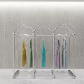 Modern Metal Clothes Rack With Multiple Hooks Holding Colorful Scarves And Garments