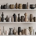 Minimalist Ceramic Vessels Collection On Shelves With Various Natural Shapes And Tones