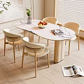 Modern Oval Marble Dining Table Set With Four Beige Chairs Natural Light And Fruit Bowl